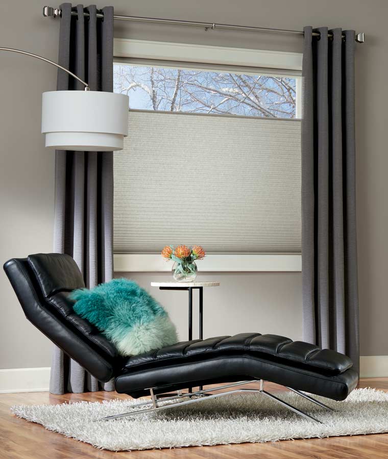 top down honeycomb shades and drapery in modern sitting area